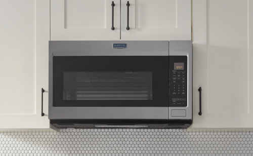 Stainless steel Maytag® over-the-range microwave set in white cabinetry