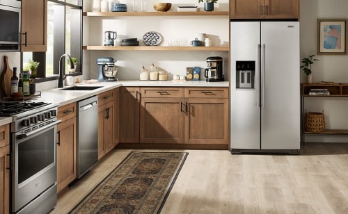 A kitchen with a stainless steel side-by-side refrigerator