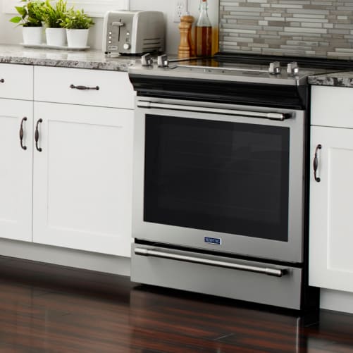 Slide-in range in a white kitchen