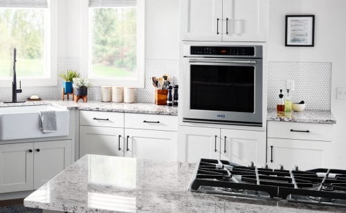 A wall oven in a white modern kitchen