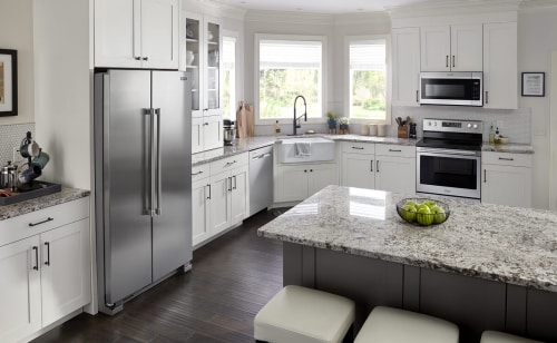 A bright, white kitchen with stainless steel appliances