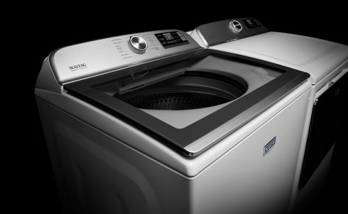 A white Maytag® top load washer and dryer