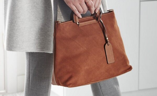 Person holding suede bag