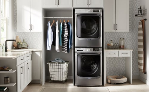 Stacked washer and dryer in a laundry closet
