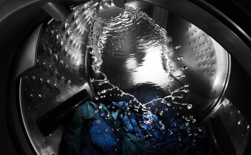 Washer basin with laundry filling with water