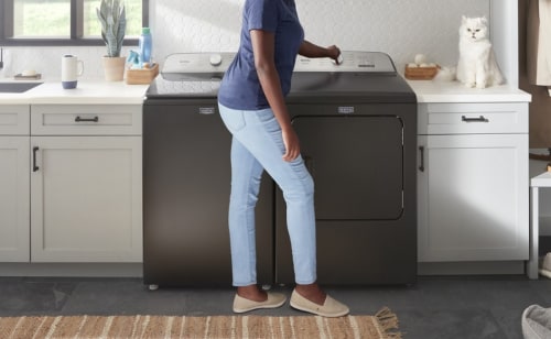 Person standing at a washing machine
