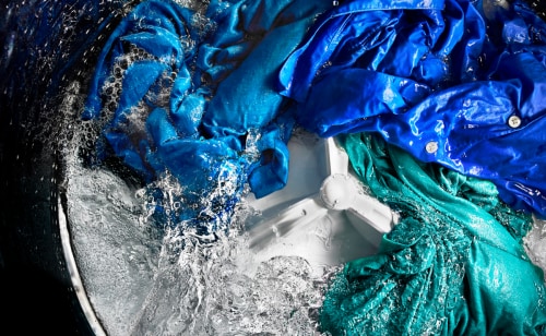 Action shot of a washing machine cleaning a load of laundry