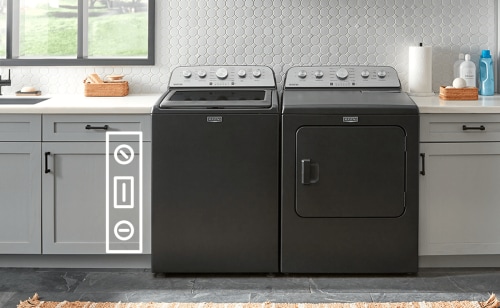 A black Maytag® washer and dryer surrounded by countertops