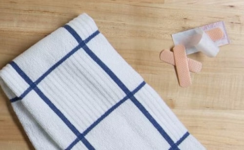 White washcloth next to first aid supplies