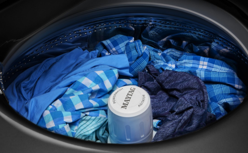 Close-up of blue clothes inside Maytag® Top Load Washer