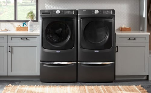 Maytag® side-by-side washer and dryer set in a modern laundry room