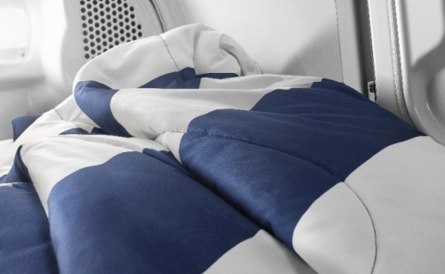 White and blue comforter inside of dryer drum