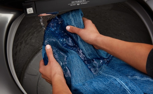Person hand washing jeans