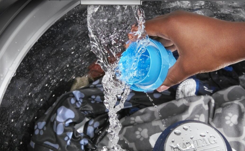 Hand rinsing a detergent cup in built-in faucet