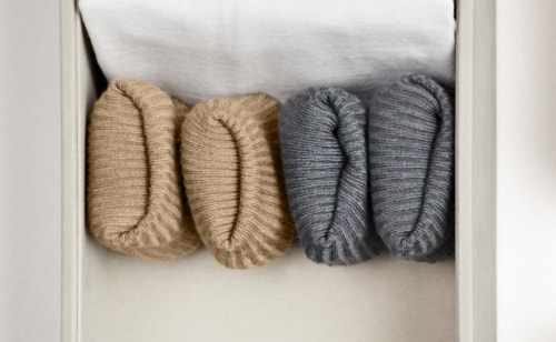 A set of folded, hand-knitted items