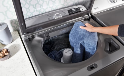 Maytag® top load washing machine filled with laundry