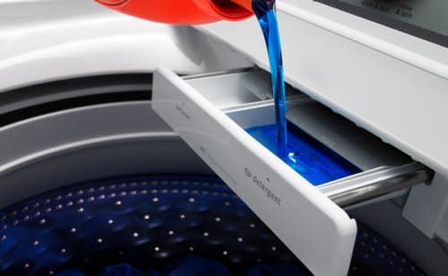 Detergent pouring into a detergent dispenser