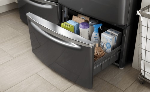 Close-up of open laundry pedestal drawer with laundry supplies inside