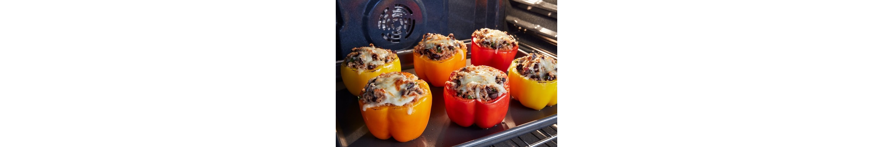 Stuffed peppers cooking inside of a Maytag® range.