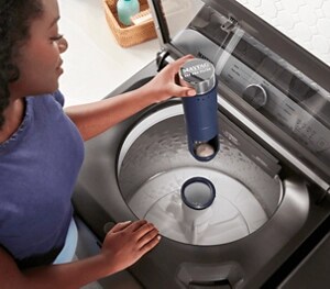 A person pulling the Pet Pro Filter out of a Maytag® washer