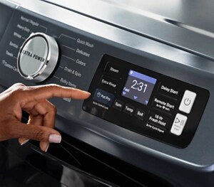 A person pressing the Pet Pro Option on a Maytag® washer