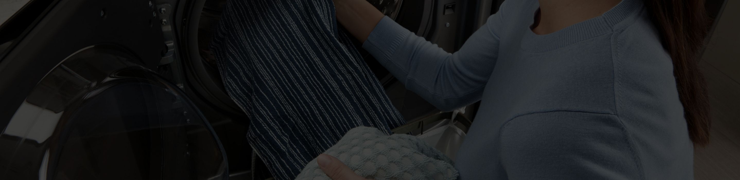Loading clothes in the washer. 