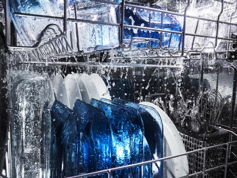 Dishes rinsing inside the dishwasher