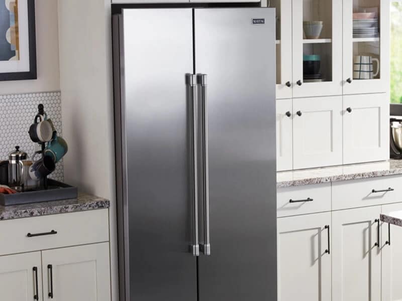 Stainless side-by-side refrigerator in a white kitchen