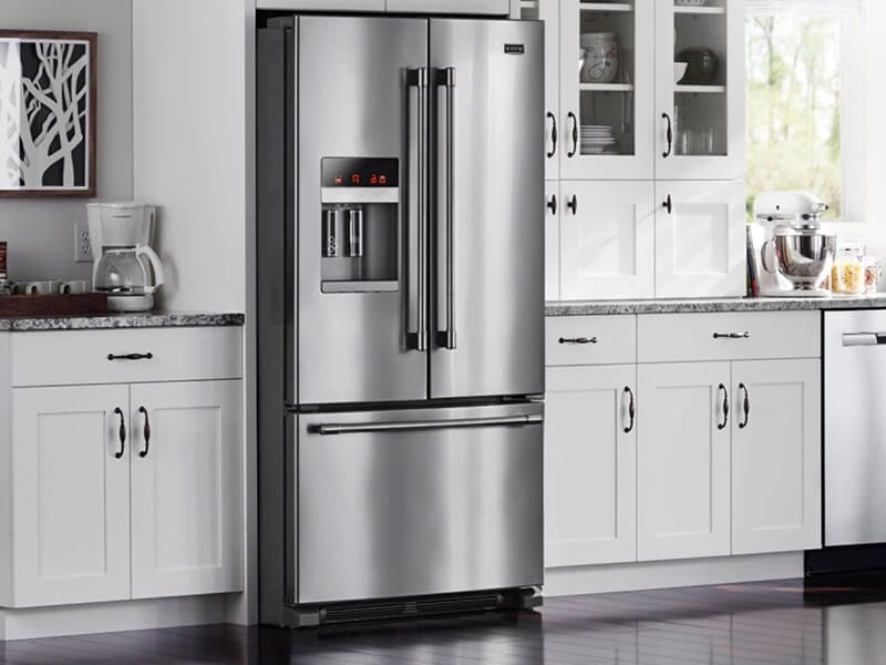 French door refrigerator in a bright, white kitchen