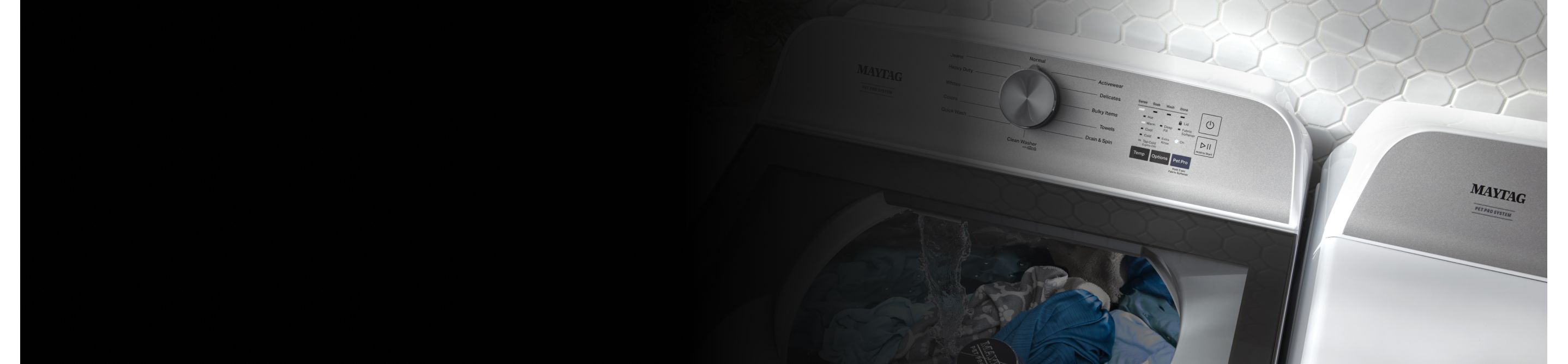 Overhead shot of large capacity Maytag® washing machine with glass lid