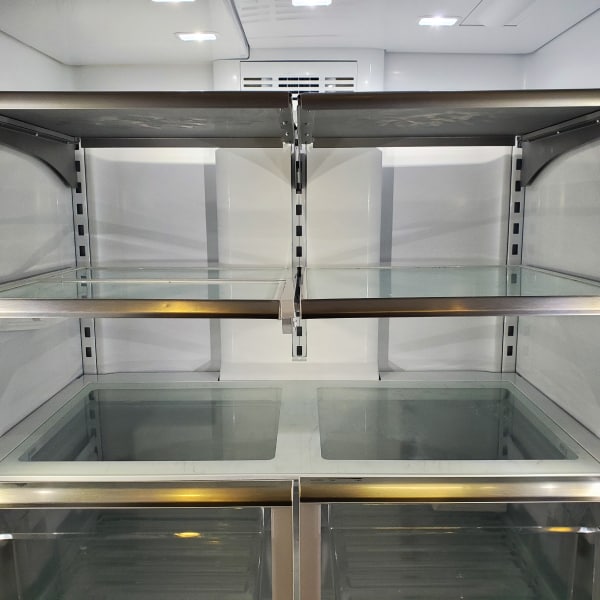 Empty refrigerator shelves and drawers.