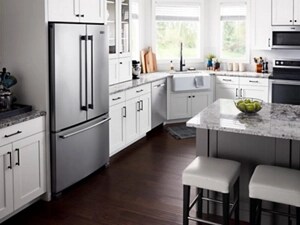 Stainless steel French door refrigerator built into white cabinetry