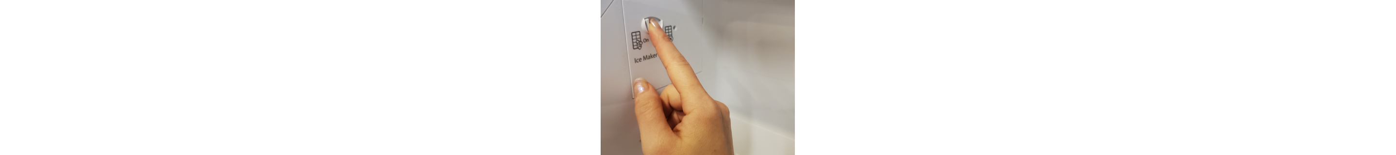  A finger pressing an ice maker button