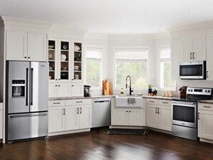 Stainless steel Maytag® appliance suite in open kitchen with white cabinetry
