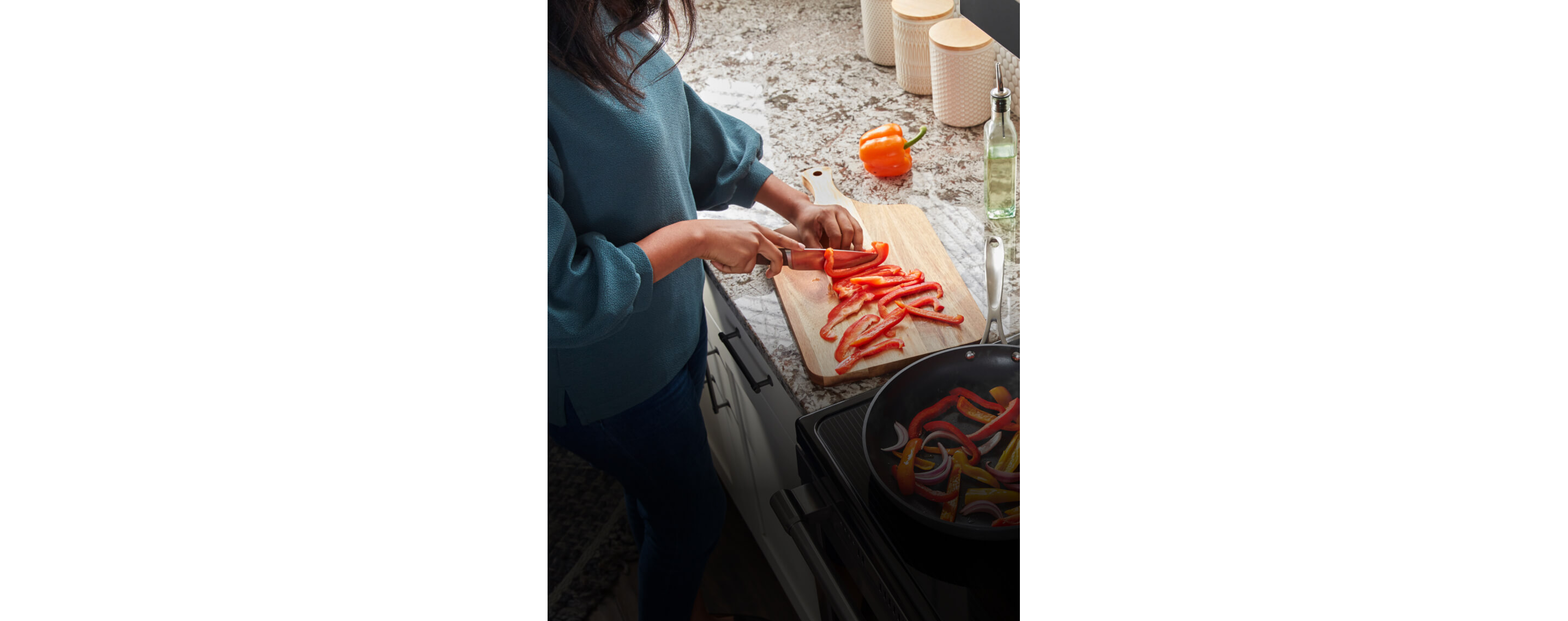 A person chopping up vegetables on a countertop.