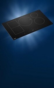 A Maytag® Induction Cooktop on a dark background.