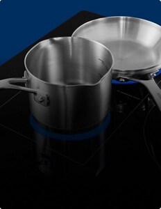 Two pans on an induction cooktop.