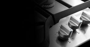 Close up of Maytag metal cooktop knobs.