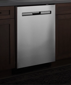 A stainless steel dishwasher against a dark background.