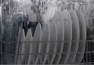 Water spraying onto dishes inside a Maytag® dishwasher
