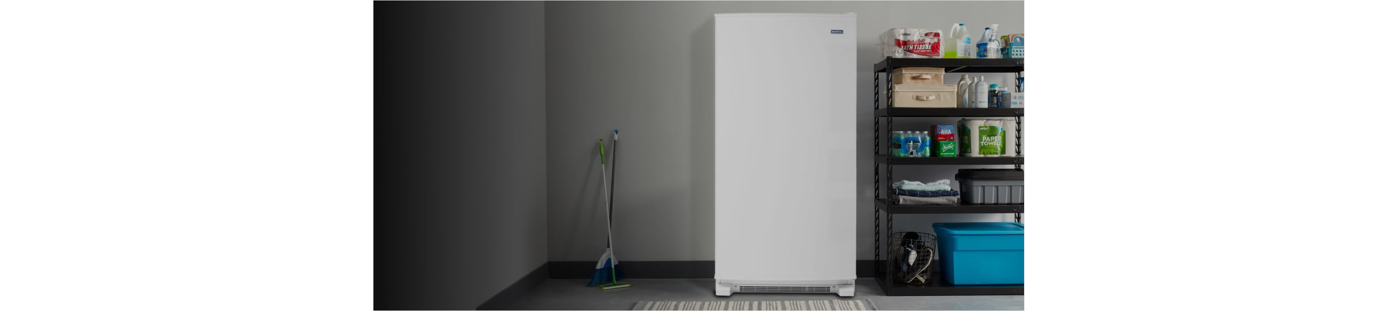 A Maytag® upright freezer in a garage.