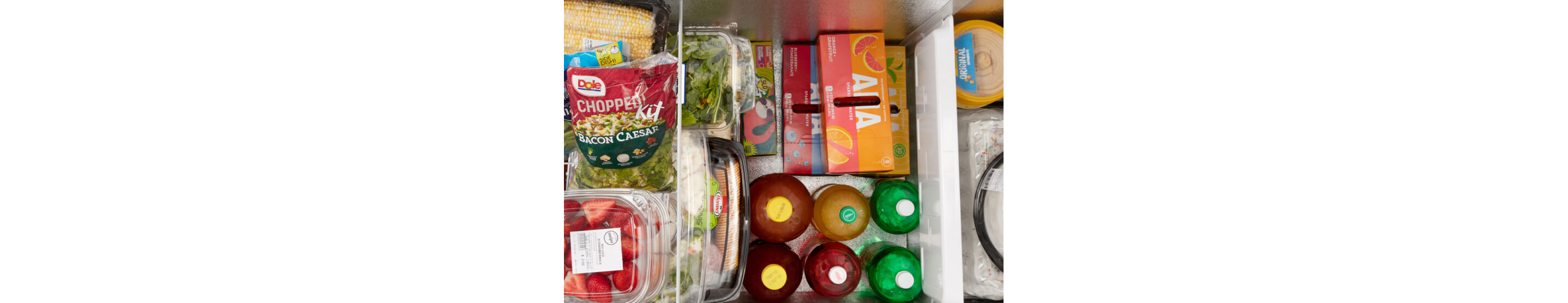 An overhead shot of an open Maytag® chest freezer with food inside.