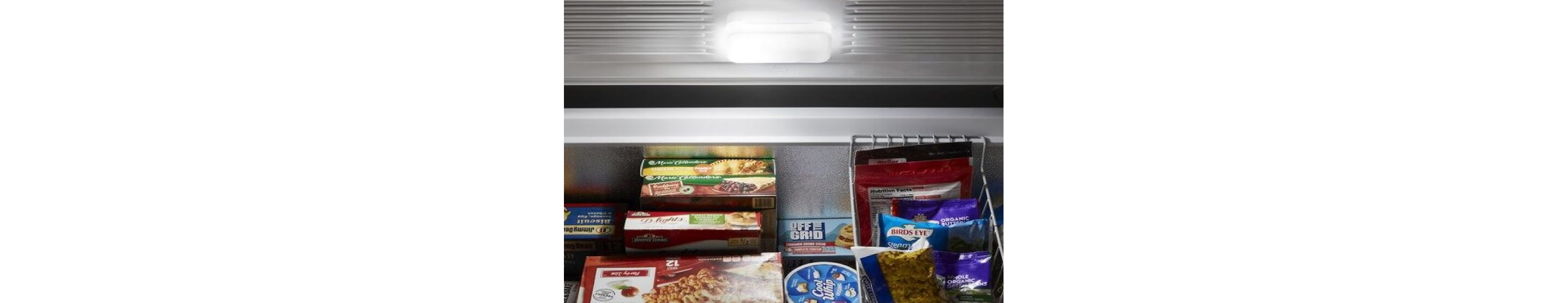 Frozen food in an open Maytag® chest freezer.