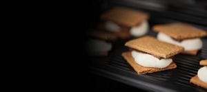 The inside of a microwave with toasted s'mores.