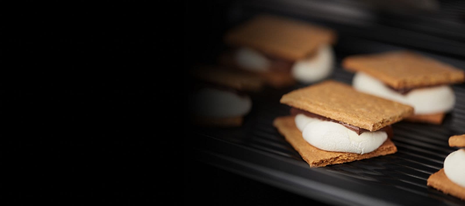 The inside of a microwave with toasted s'mores.