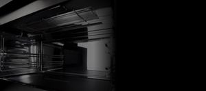 An open microwave with a dish inside.