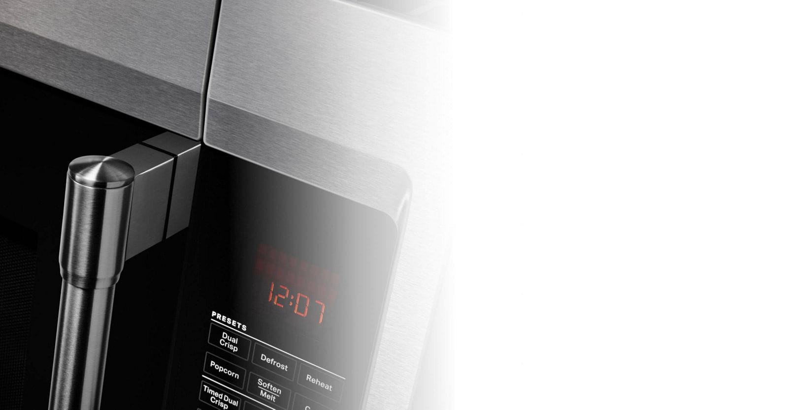 Close up of microwave handle and control panel.