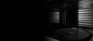 An empty microwave with a stainless steel cavity.