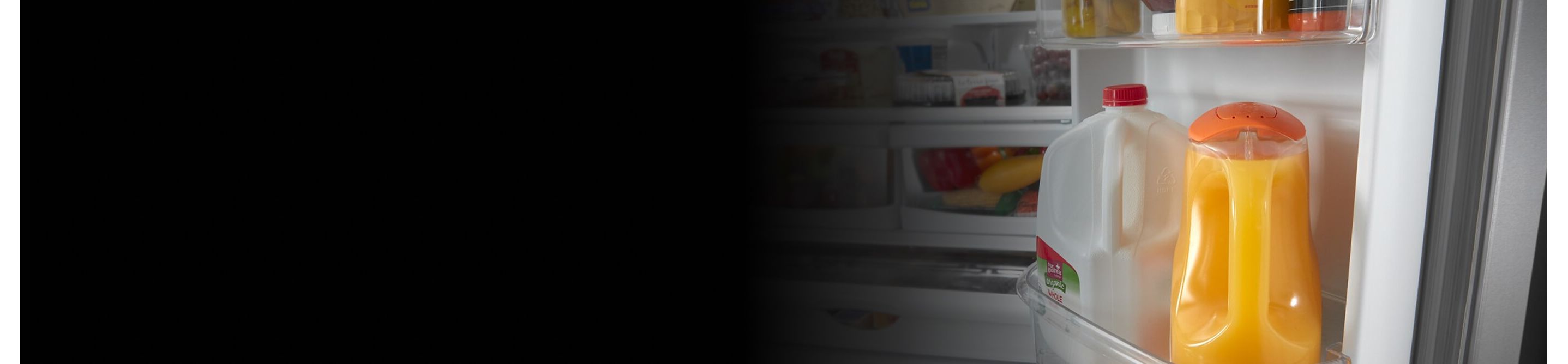 Orange juice and milk inside a refrigerator door