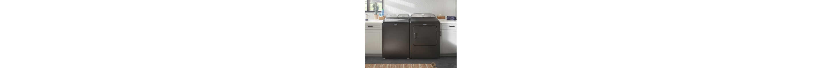 Top load washer and dryer set in a laundry room